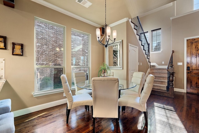 dining room with a chandelier, crown molding, and dark wood-type flooring