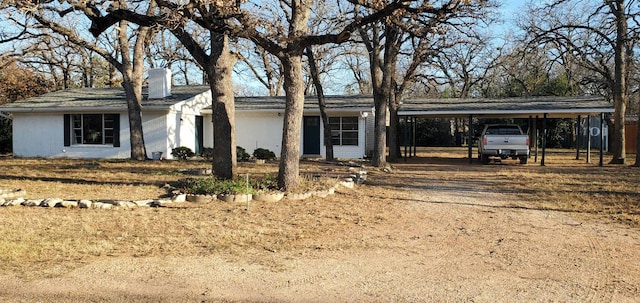 single story home featuring a carport