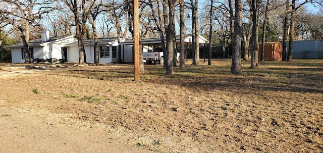 exterior space with a carport and a storage shed