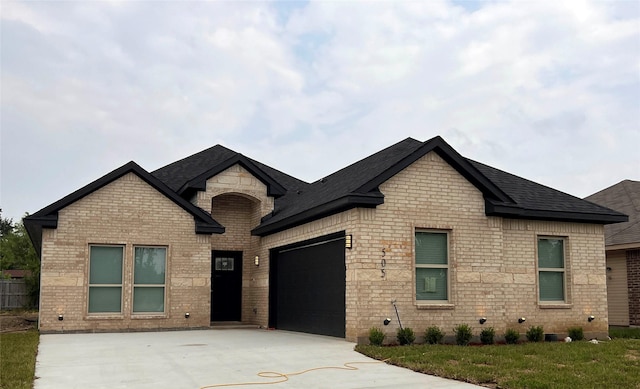 french country style house with a garage