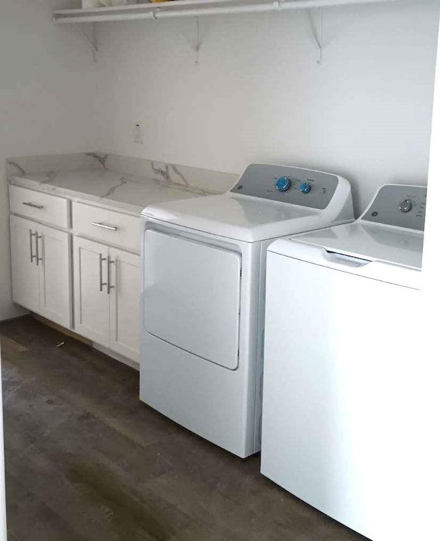 washroom with cabinets and washing machine and dryer