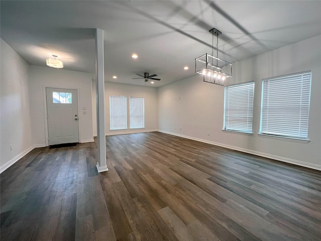 foyer entrance with ceiling fan and dark wood-type flooring