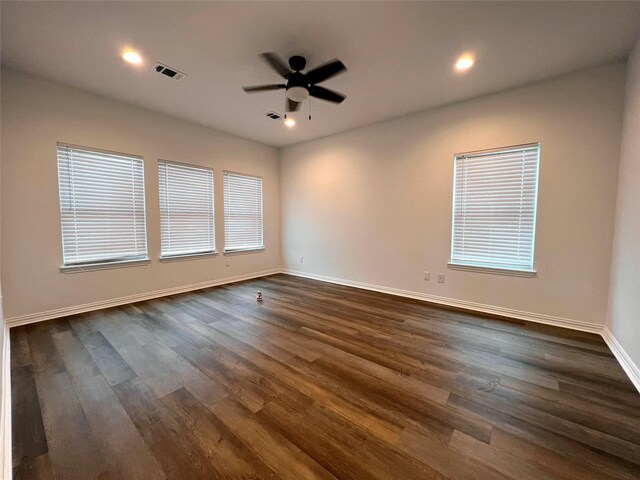 spare room featuring ceiling fan and dark hardwood / wood-style flooring