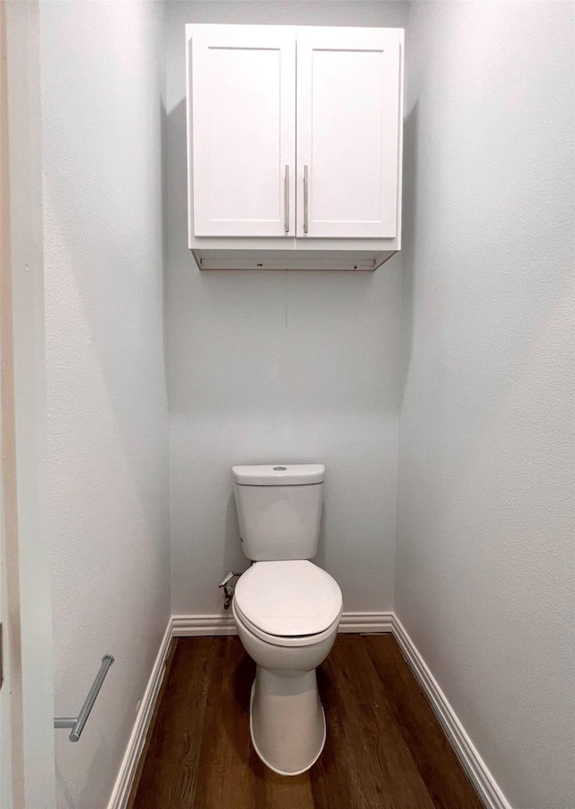 bathroom with toilet and hardwood / wood-style flooring