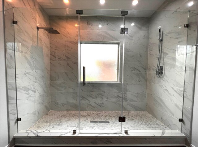 bathroom featuring a shower with shower door