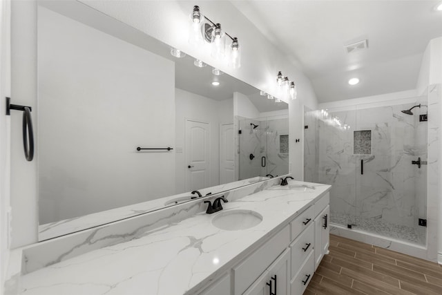 bathroom featuring vanity and a shower with shower door