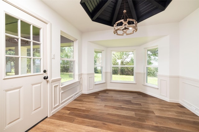 unfurnished sunroom with an inviting chandelier, wood ceiling, and beam ceiling