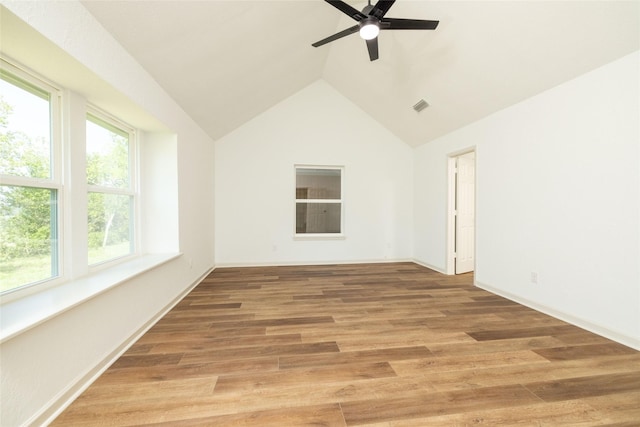 spare room with hardwood / wood-style flooring, lofted ceiling, and ceiling fan