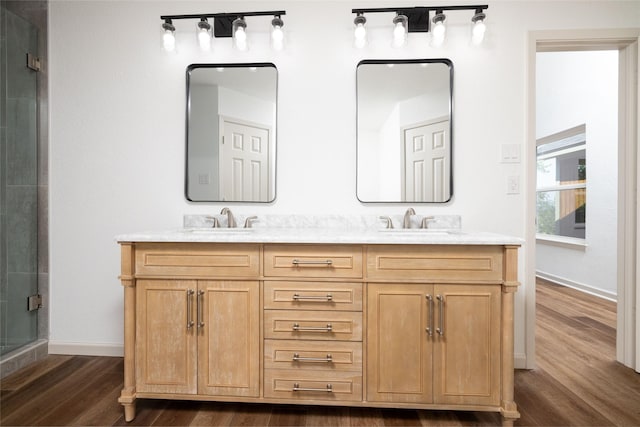 bathroom with vanity, hardwood / wood-style flooring, and a shower with shower door