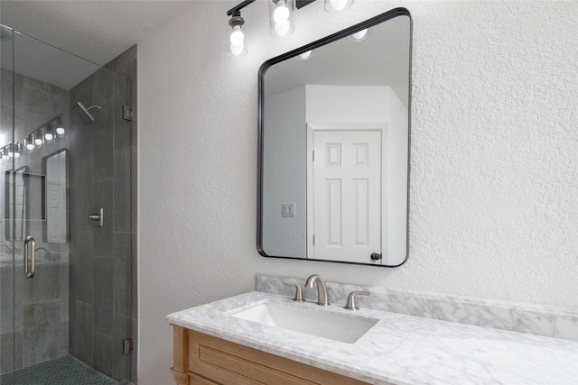 bathroom with vanity and a shower with shower door