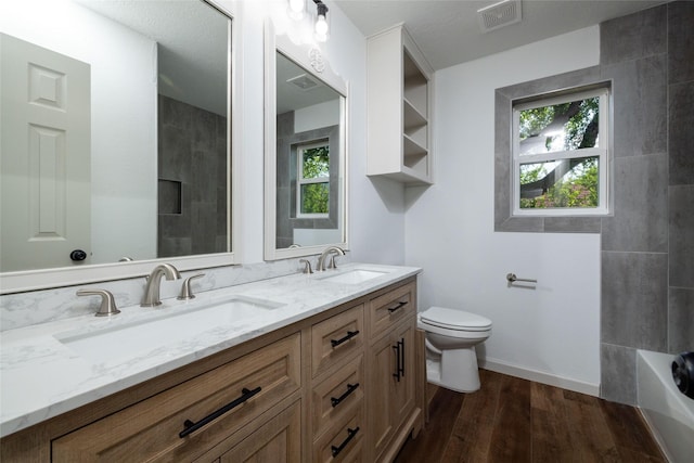 bathroom featuring vanity, wood-type flooring, and toilet