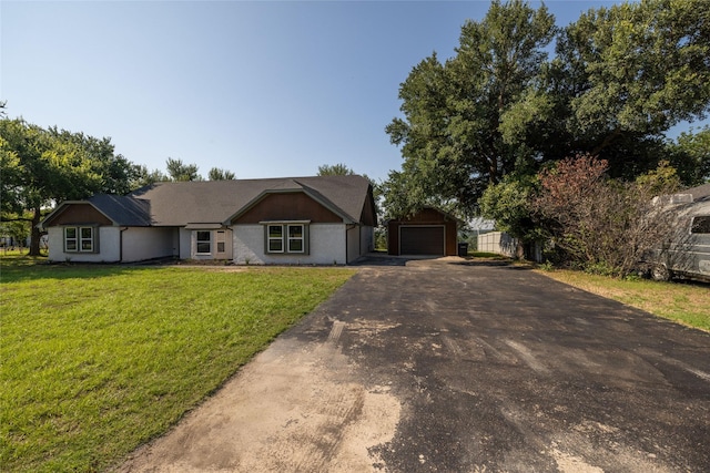 ranch-style home with a garage, an outdoor structure, and a front lawn