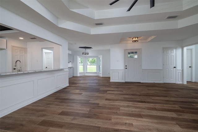 entryway featuring a tray ceiling and dark hardwood / wood-style floors