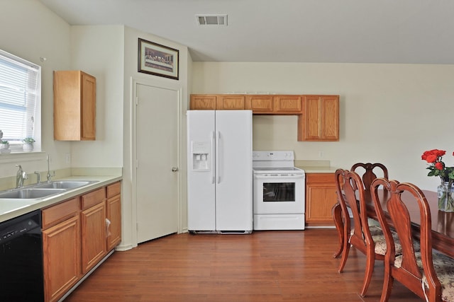 kitchen with dark hardwood / wood-style flooring, sink, and white appliances