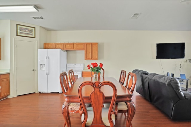 dining space with wood-type flooring