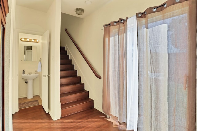 stairway featuring sink and wood-type flooring