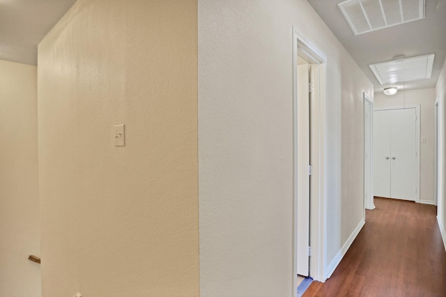 corridor with dark hardwood / wood-style flooring