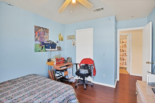 bedroom with dark hardwood / wood-style floors and ceiling fan