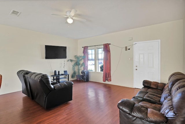 living room featuring ceiling fan and dark hardwood / wood-style flooring