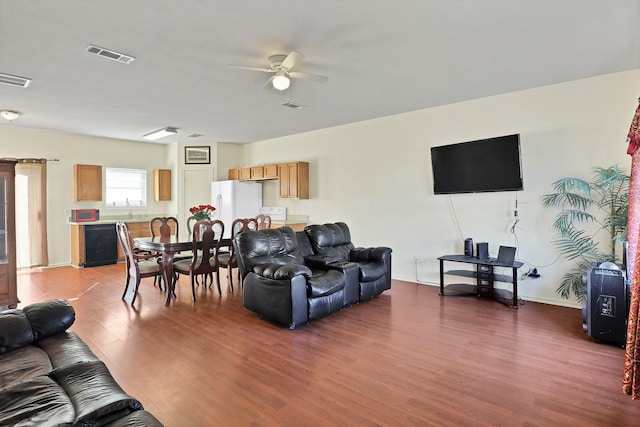 living room featuring dark hardwood / wood-style flooring and ceiling fan