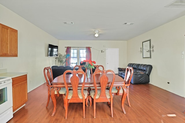 dining area featuring wood-type flooring and ceiling fan