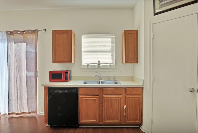 kitchen with black appliances, dark hardwood / wood-style flooring, and sink