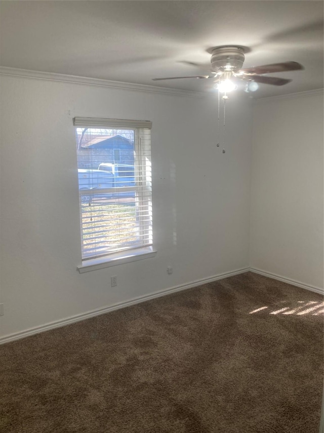 carpeted spare room with ceiling fan and crown molding