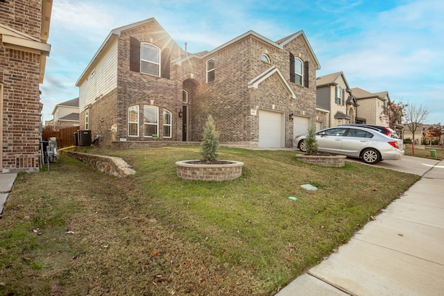 view of front of home with central AC, a garage, and a front lawn