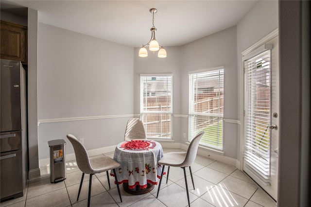 tiled dining area with a notable chandelier