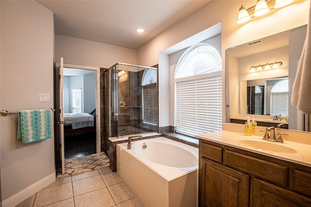 bathroom featuring plus walk in shower, tile patterned flooring, and vanity