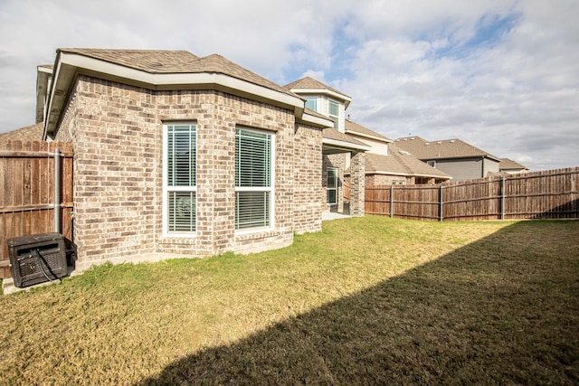 rear view of property with a yard