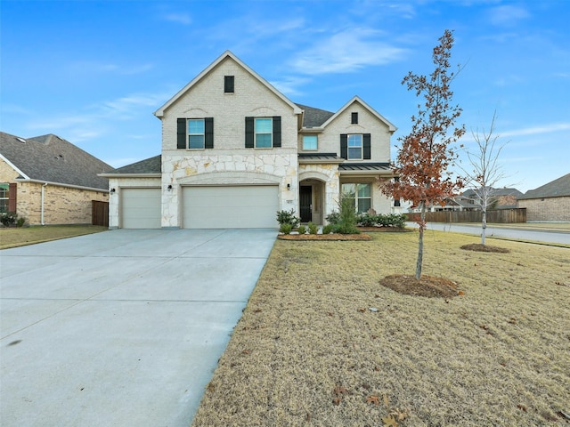 view of front of house featuring a garage and a front yard