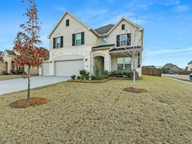 view of front of property featuring a front yard and a garage