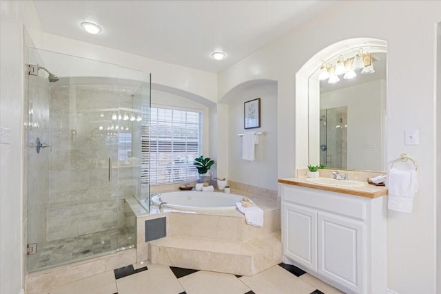 bathroom featuring a garden tub, a shower stall, tile patterned flooring, and vanity