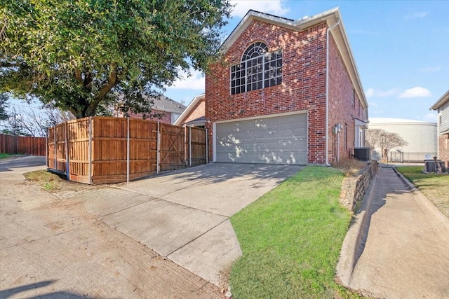 view of side of property with a garage and cooling unit