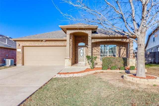 view of front of home featuring central AC unit and a garage