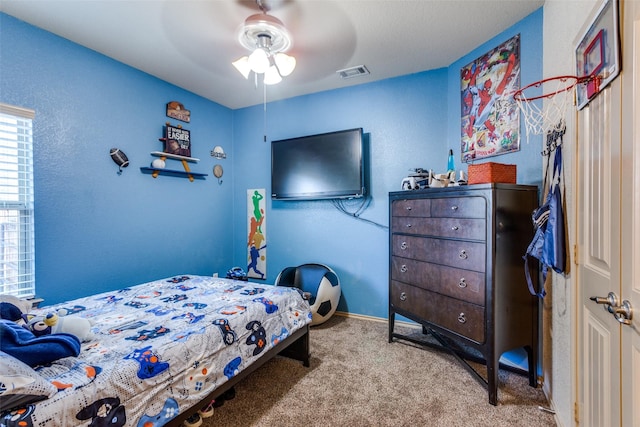 bedroom featuring ceiling fan and light colored carpet