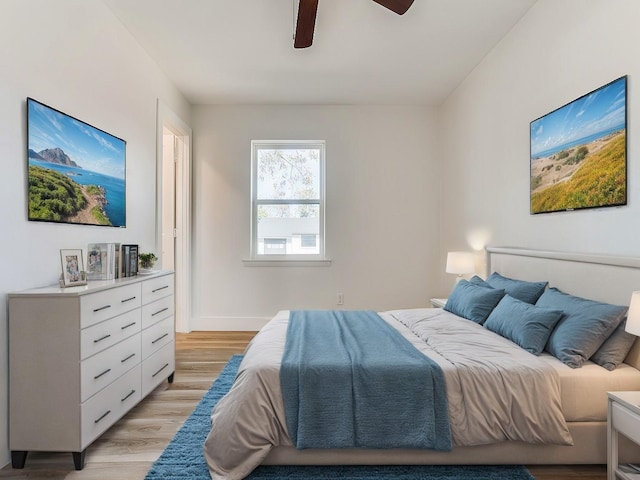 bedroom with ceiling fan and light wood-type flooring