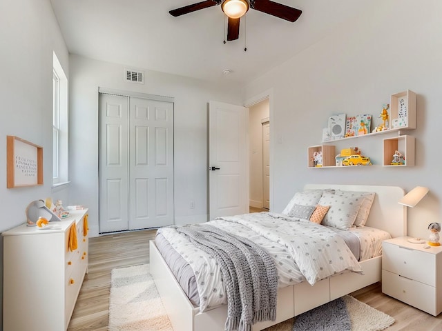 bedroom featuring ceiling fan, a closet, and light hardwood / wood-style flooring