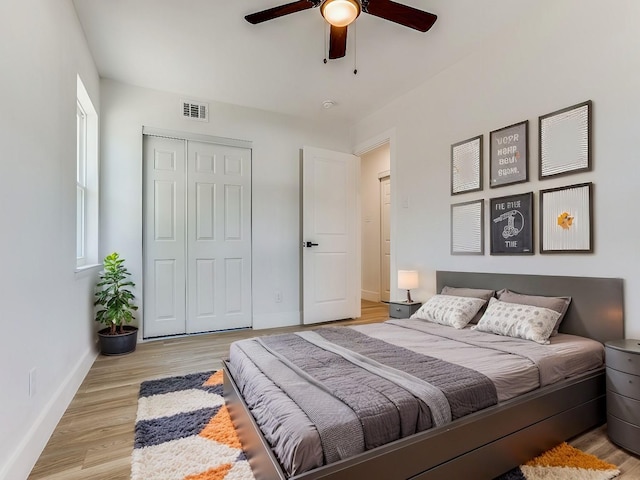 bedroom featuring ceiling fan, a closet, and light hardwood / wood-style floors