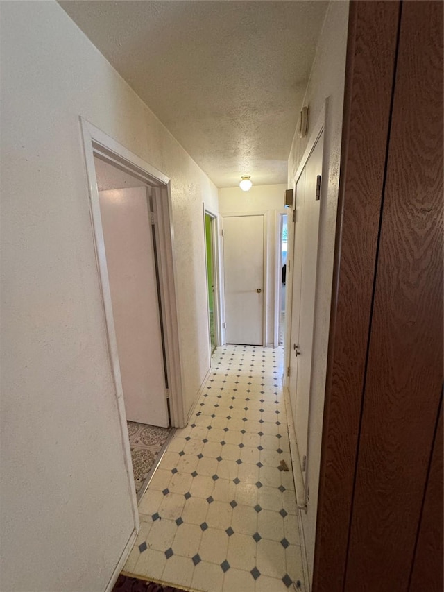 hallway featuring a textured ceiling