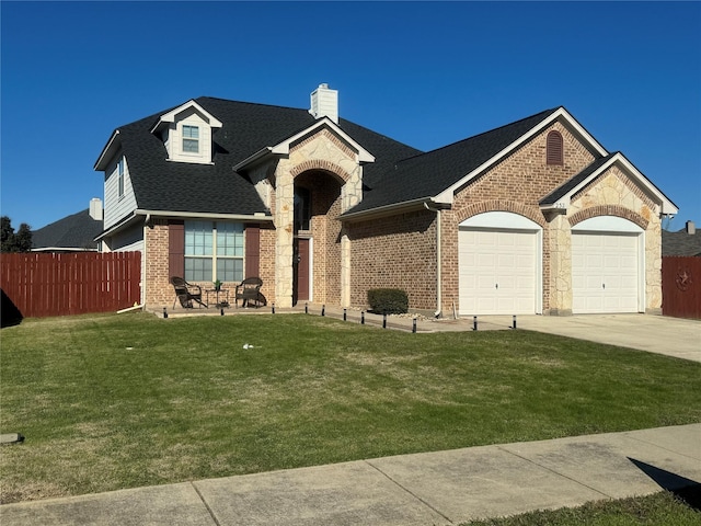 view of front of house featuring a front yard and a garage