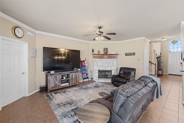 living room with ceiling fan, a fireplace, light tile patterned flooring, and crown molding