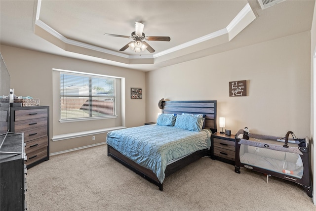 bedroom featuring carpet floors, a raised ceiling, and ceiling fan