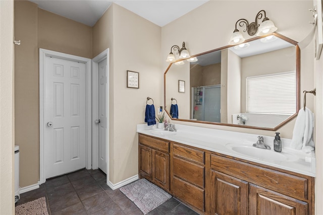 bathroom featuring tile patterned floors, a shower with door, and vanity