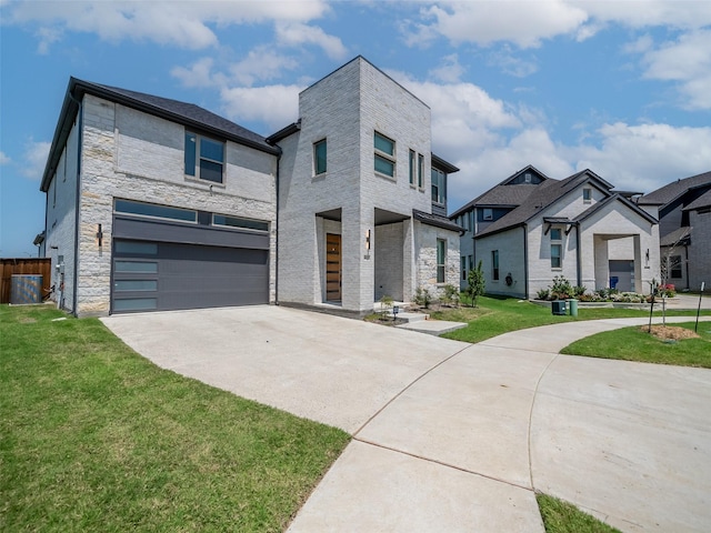 modern home with a front lawn and a garage