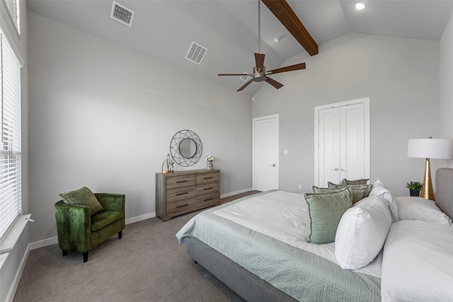 bedroom featuring carpet flooring, multiple windows, ceiling fan, and lofted ceiling with beams