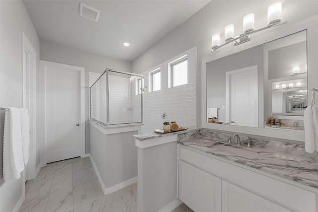 bathroom featuring vanity and an enclosed shower