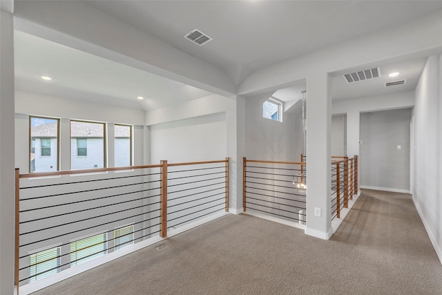 hallway with light colored carpet