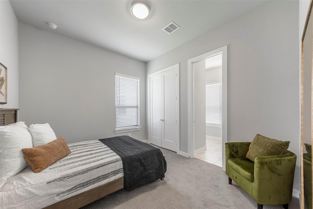 carpeted bedroom with a closet